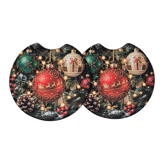 Two oval-shaped coasters with a festive Christmas design, featuring red ornaments, pinecones, evergreen trees, and lights, displayed side-by-side on a white background.